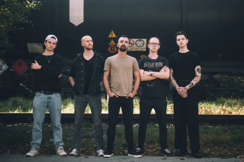 All Veritate members standing in front of a train